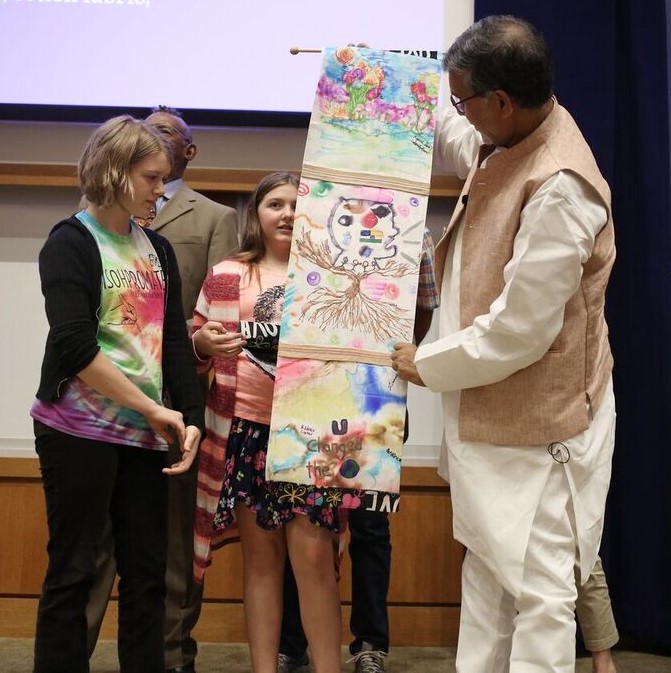 gatton-satyarthi-examining-scrolls-2-cropped